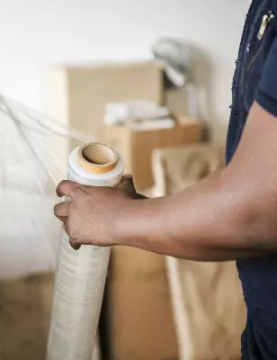 Man packing and moving furniture